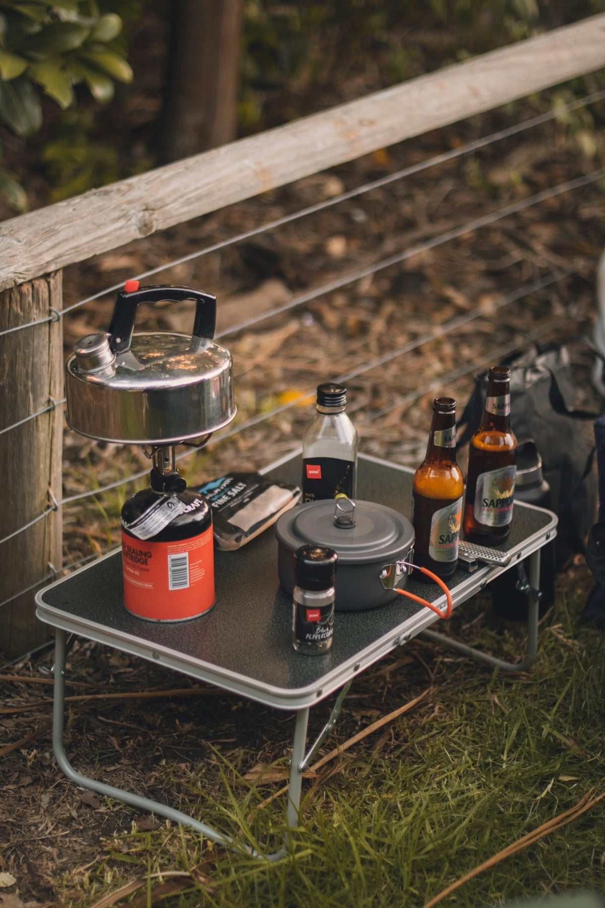a camping table with a pot and pan on it