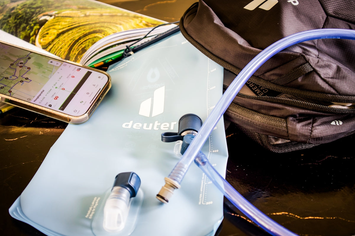 Hiking gear: water bladder, backpack, and phone map.